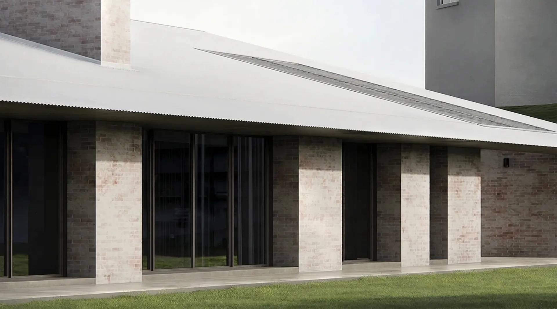 Contemporary building faced with eco brick columns above a paved walkway